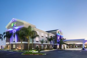 dusk exterior of Holiday Inn Express & Suites Yosemite Pk Chowchilla