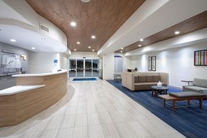 lobby area seating and front desk and entry